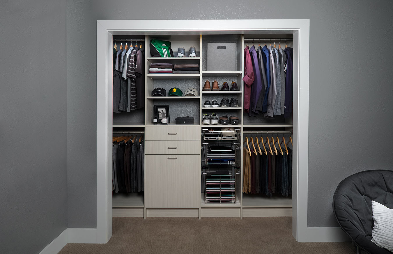 Custom reach-in closet design with built-in drawers and double hanging rods in Los Angeles