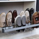 Angled shoe shelves with metal fences for sneaker display